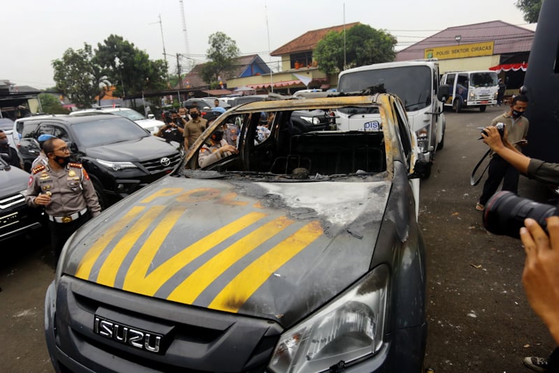 SELIDIKI MOTIF: Petugas membawa mobil yang rusak akibat penyerangan pada Sabtu dini hari (29/8) tersebut. (SALMAN TOYIBI/JAWA POS) - Image