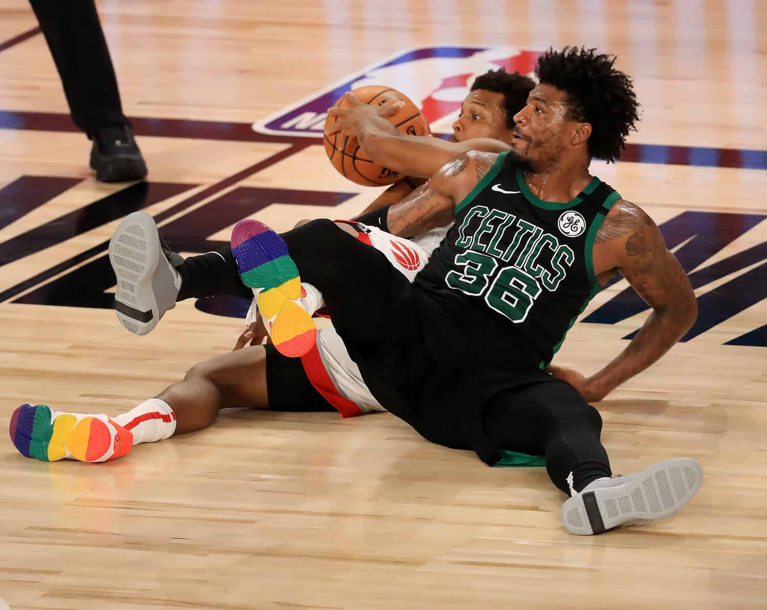 LAKE BUENA VISTA, FLORIDA - SEPTEMBER 01: Kyle Lowry #7 of the Toronto Raptors and Marcus Smart #36 of the Boston Celtics wrestle for a loose ball to the floor during the fourth quarter in Game Two of the Eastern Conference Second Round during the 2020 NB - Image