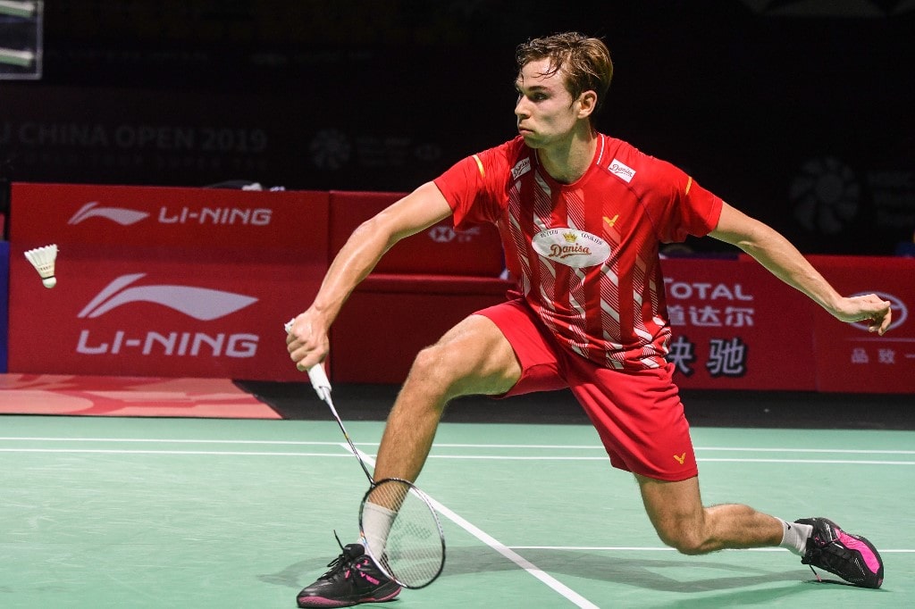 Rasmus Gemke of Denmark hits a return against Kento Momota of Japan during their men - Image