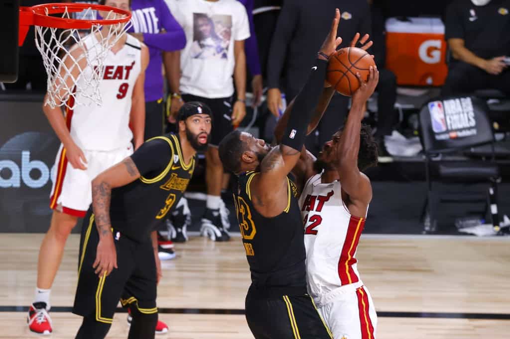 LAKE BUENA VISTA, FLORIDA - OCTOBER 02: Jimmy Butler #22 of the Miami Heat drives to the basket against LeBron James #23 of the Los Angeles Lakers during the second half in Game Two of the 2020 NBA Finals at AdventHealth Arena at ESPN Wide World Of Sports - Image