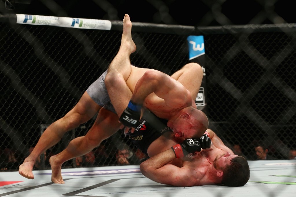 NEW YORK, NY - NOVEMBER 04: Georges St-Pierre of Canada brings down Michael Bisping of England in their UFC middleweight championship bout during the UFC 217 event at Madison Square Garden on November 4, 2017 in New York City. Mike Stobe/Getty Images/AF - Image