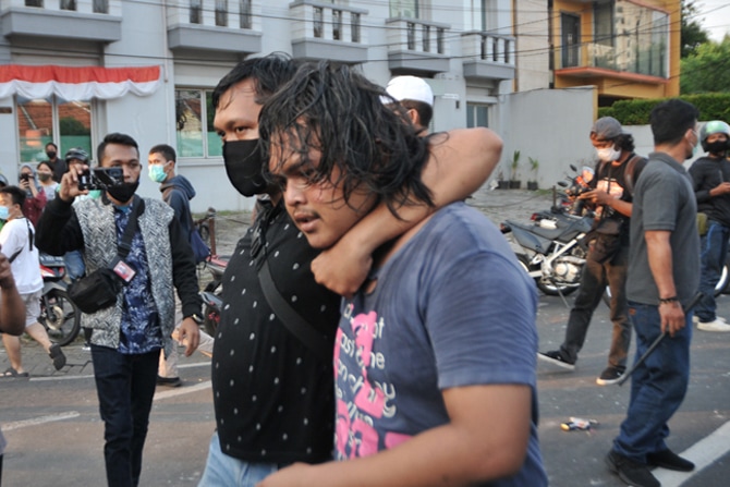 Aparat Kepolisian mengamankan salah satu massa yang terlibat bentrok di Jalan Pejompongan Raya, Bendungan Hilir, Jakarta Pusat, Rabu (7/10/2020). Aksi massa tersebut sebagai bentuk penolakan atas disahkannya Omnibus Law UU Cipta Kerja oleh DPR pada Senin - Image