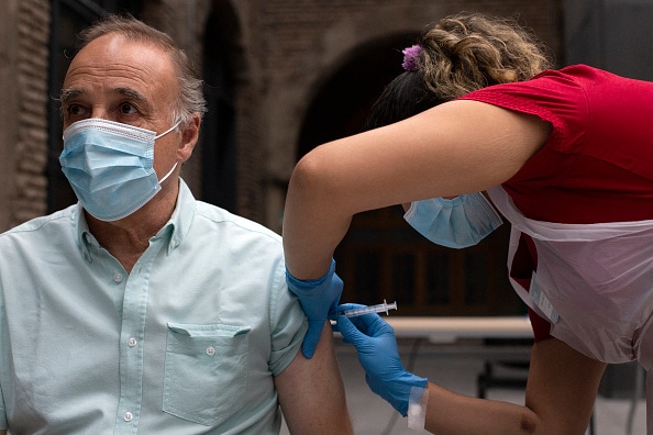 A health worker administers a dose of the Chinese CoronaVac vaccine against COVID-19 to a man at a vaccination centre in Santiago, on March 16, 2021. - The vaccination campaign is about to surpass the barrier of 5 million people inoculated in Chile. (Phot - Image