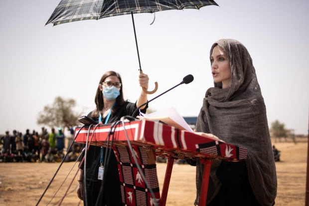 US actress Angelina Jolie, United Nations High Commissioner for Refugees (UNHCR) special envoy, gives a statement in Goudebo, a camp that welcomes more than 11,000 Malian refugees in northern Burkina Faso, on International Refugee Day on June 20, 2021. - - Image