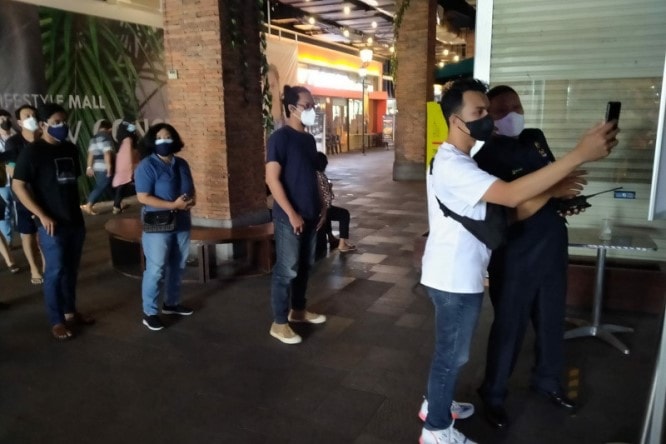 Salah satu pengunjung sedang mencoba aplikasi PeduliLindungi sebagai salah satu syarat masuk mal. Mal Solo Paragon/Antara - Image