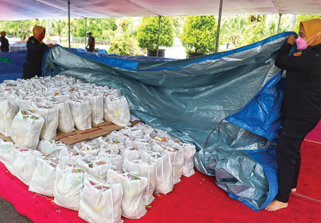 BERSUMBER DARI DAERAH: Pegawai Pemkot Surabaya menyiapkan bantuan sembako. Rencananya, 19.054 keluarga penerima manfaat (KPM) akan mendapatkan bantuan dana dari APBD Surabaya. (Frizal/Jawa Pos) - Image