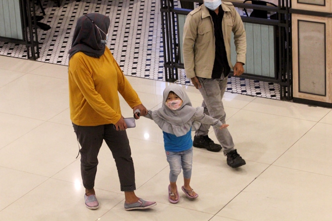 Seorang anak bersama orang tuanya saat berkunjung di Mall Tangerang City Kota Tangerang, Banten, Minggu (10/10/2021). Pemerintah mengizinkan anak usia di bawah 12 tahun masuk ke mal dan pusat perbelanjaan pada masa perpanjangan PPKM Level 3 dengan syarat - Image