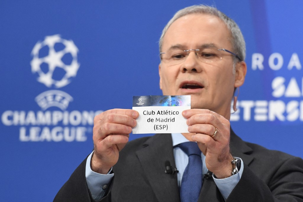 In this handout picture released by the UEFA, UEFA Deputy General Secretary Giorgio Marchetti holds the name of Atletico de Madrid during the Champions League round of 16 draw at the UEFA headquarters in Nyon, on December 13, 2021. - The first legs are sc - Image