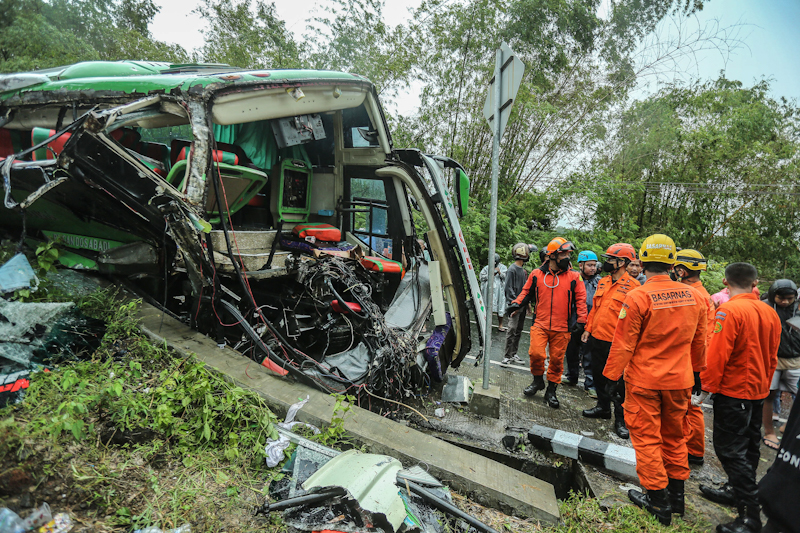 Petugas Basarnas usai mengevakuasi korban penumpang bus pariwisata yang hancur karena menghantam tebing di Jalan Dlingo-Imogiri, Kedungguweng, Wukirsari, Imogiri, Bantul, Minggu (6/2). Diduga kecelakaan akibat rem blong dan sopir tidak menguasai medan (Fo - Image