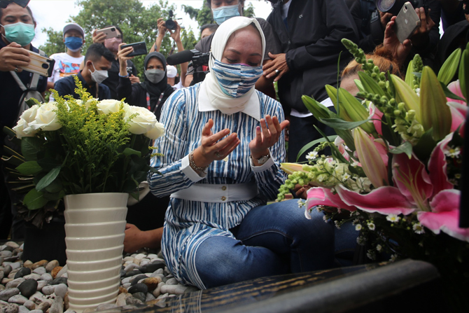 Angelina Sondakh saat berziarah ke makam suaminya, Adjie Massaid di Taman Pemakaman Umum (TPU) Jeruk Purut, Cilandak, Jakarta Selatan, Kamis (3/3/2022). Mantan anggota DPR RI Angelina Patricia Pinkan Sondakh atau Angelina Sondakh berziarah ke makam mendia - Image