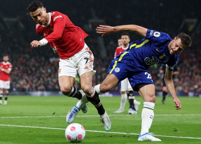 Penyerang Manchester United Cristiano Ronaldo (kiri) berebut bola dengan bek Chelsea Cesar Azpilicueta dalam pertandingan Liga Inggris pada Jumat (29/4). Phil Noble/Reuters/Antara - Image