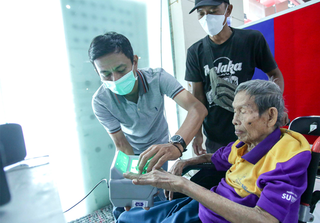 PELAYANAN CEPAT: Suwito melakukan perekaman e-KTP ulang untuk memperbaiki foto di kantor Dispendukcapil Surabaya di gedung Siola, Sabtu (2/4). Alfian Rizal/Jawa Pos - Image