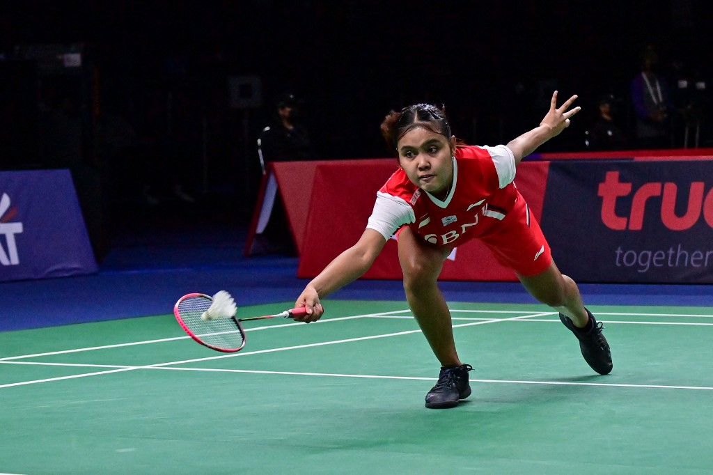 Indonesias Bilqis Prasista hits a return against Frances Yaelle Hoyaux during the group stages of the Thomas and Uber Cup badminton tournament in Bangkok on May 8, 2022. (Photo by Lillian SUWANRUMPHA / AFP) - Image