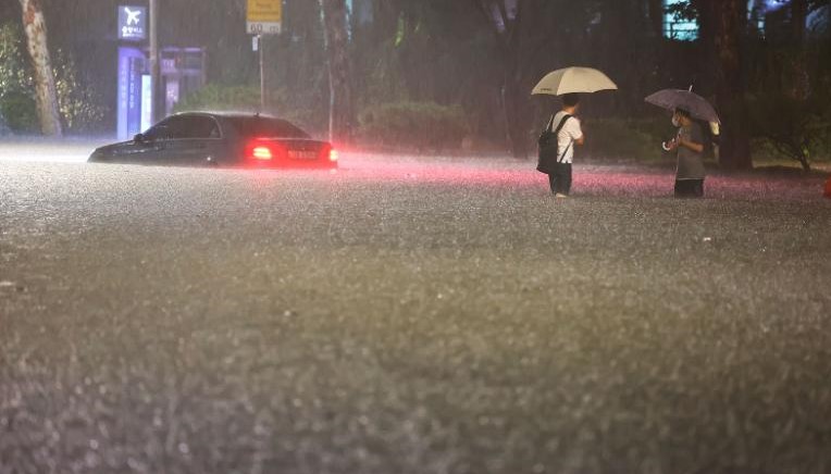 A vehicle is submerged in a flooded road in Seoul, Monday, Aug. 8, 2022. Heavy rains drenched South Korea - Image