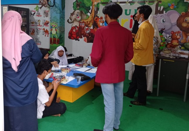 Mahasiswa ikut ambil bagian dalam program sinau bareng di Balai RW. Grace Natashia/JawaPos.com - Image