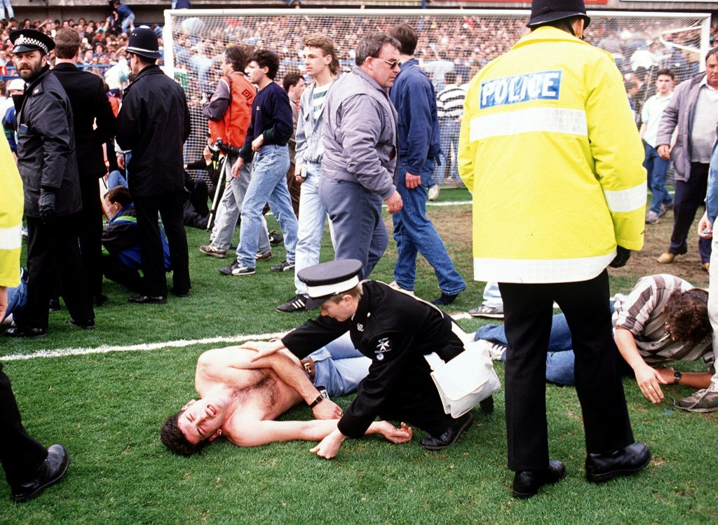 (FILES) This file photo taken on April 15, 1989 shows soccer fans at Hillsborough stadium when 96 fans were crushed to death and hundreds injured after support railings collapsed during a match between Liverpool and Nottingham forest. - The stampede at a - Image
