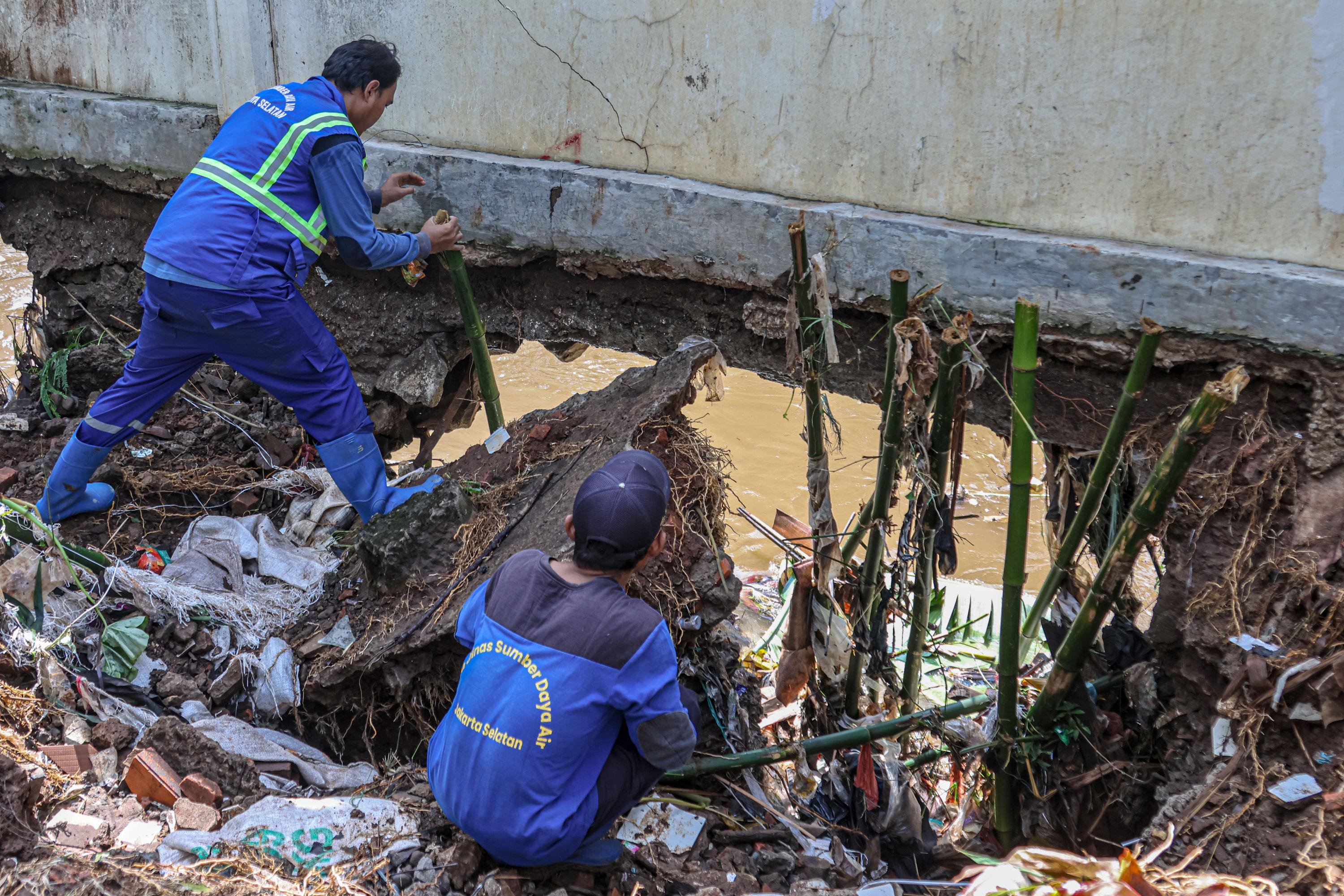 Petugas dari Dinas Sumber Saya Air DKI memperbaiki tanggul sungai Krukut di kawasan Kemang, Jakarta Selatan.