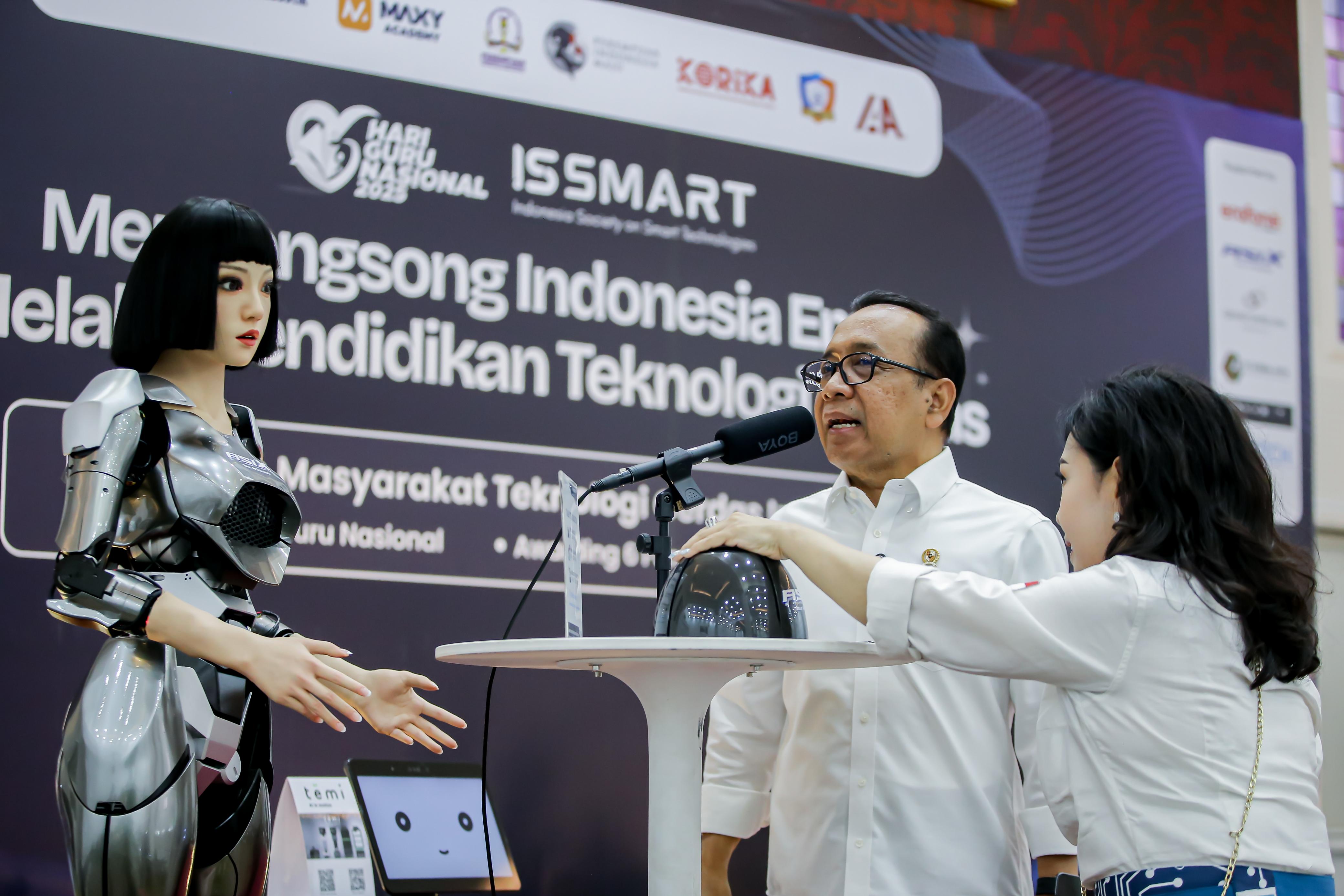 Menko PMK Pratikno berkomunikasi dengan robot wanita di Kantor Kemenko PMK, Jakarta, Rabu (3/12).